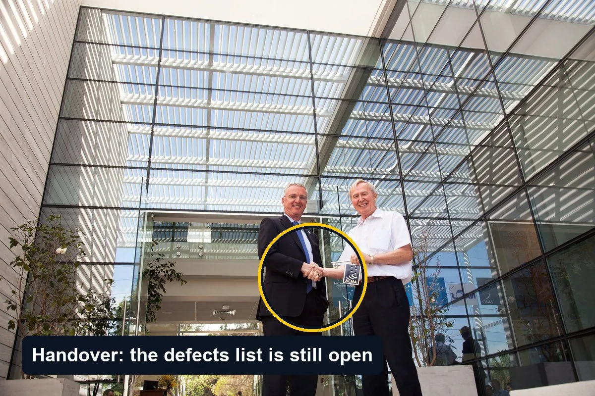Two men shaking hands and exchanging a key-like object in the glazed entrance hall of a newly completed office building, circled, with the label Handover: the defects list is still open